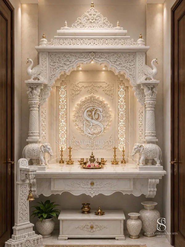 Built-in white marble pooja niche with elephants, pillars and an Om panel