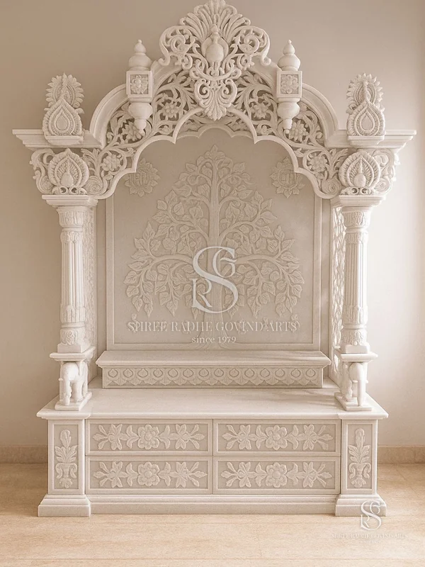 White marble mandir with a tree of life panel and carved shikhar