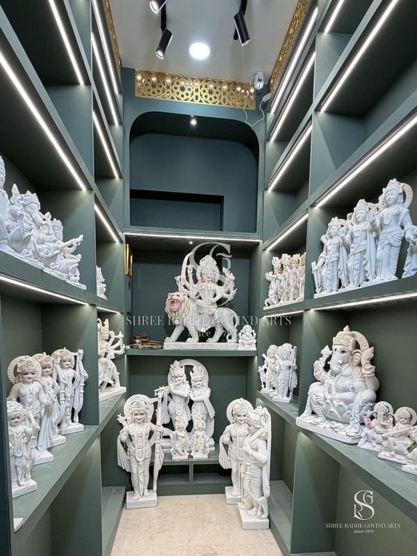Inside the Shree Radhe Govind Arts showroom, shelves of white marble moortis